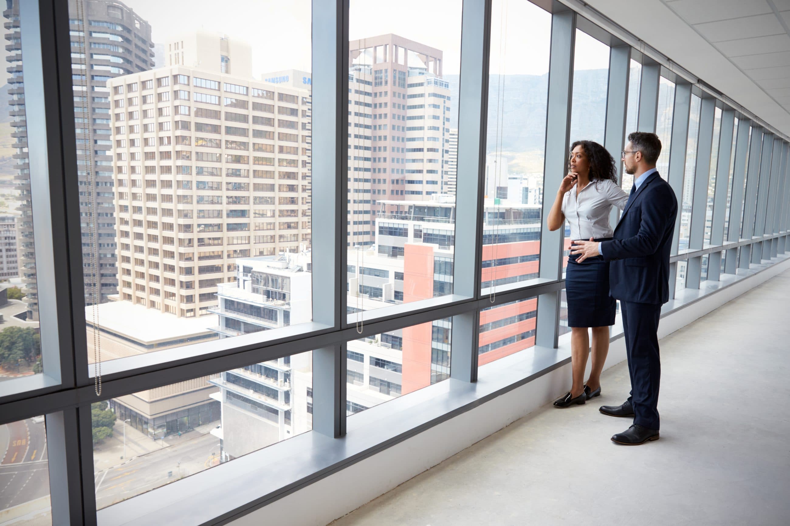 two people stood in an empty office building